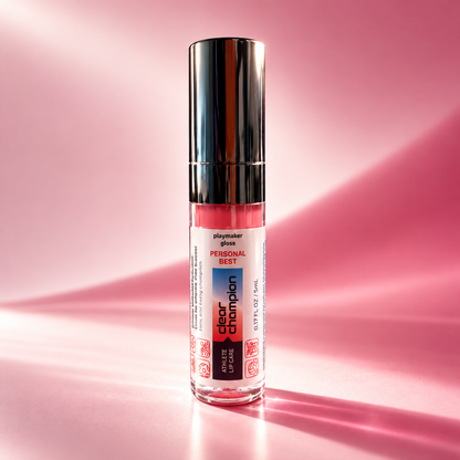 A bottle of playmaker gloss by Clear Champion Personal Best lip gloss in a vibrant pink shade, featuring a reflective silver cap, set against a pink background with soft light rays.